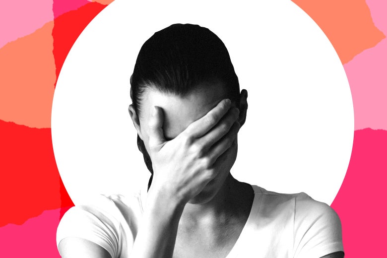 A woman holds her head in her hand.